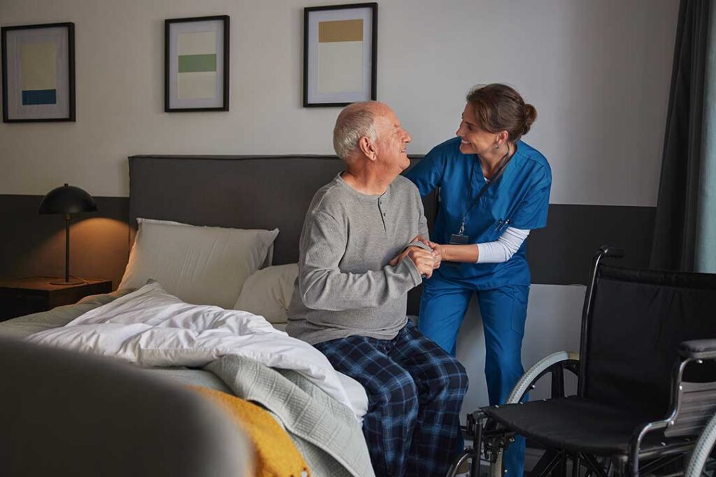 Family member reviews a medication list with an older adult at a kitchen table.